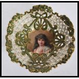 An early 20th Century Coalport fret pierced tazza bowl having a hand painted portrait of a lady to