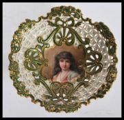 An early 20th Century Coalport fret pierced tazza bowl having a hand painted portrait of a lady to