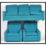 A vintage retro three piece suite comprising sofa and two arm chairs in woollen Bitossi colours,