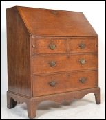 An 18th century Georgian oak bureau having a fall front with fully appointed interior. Two over