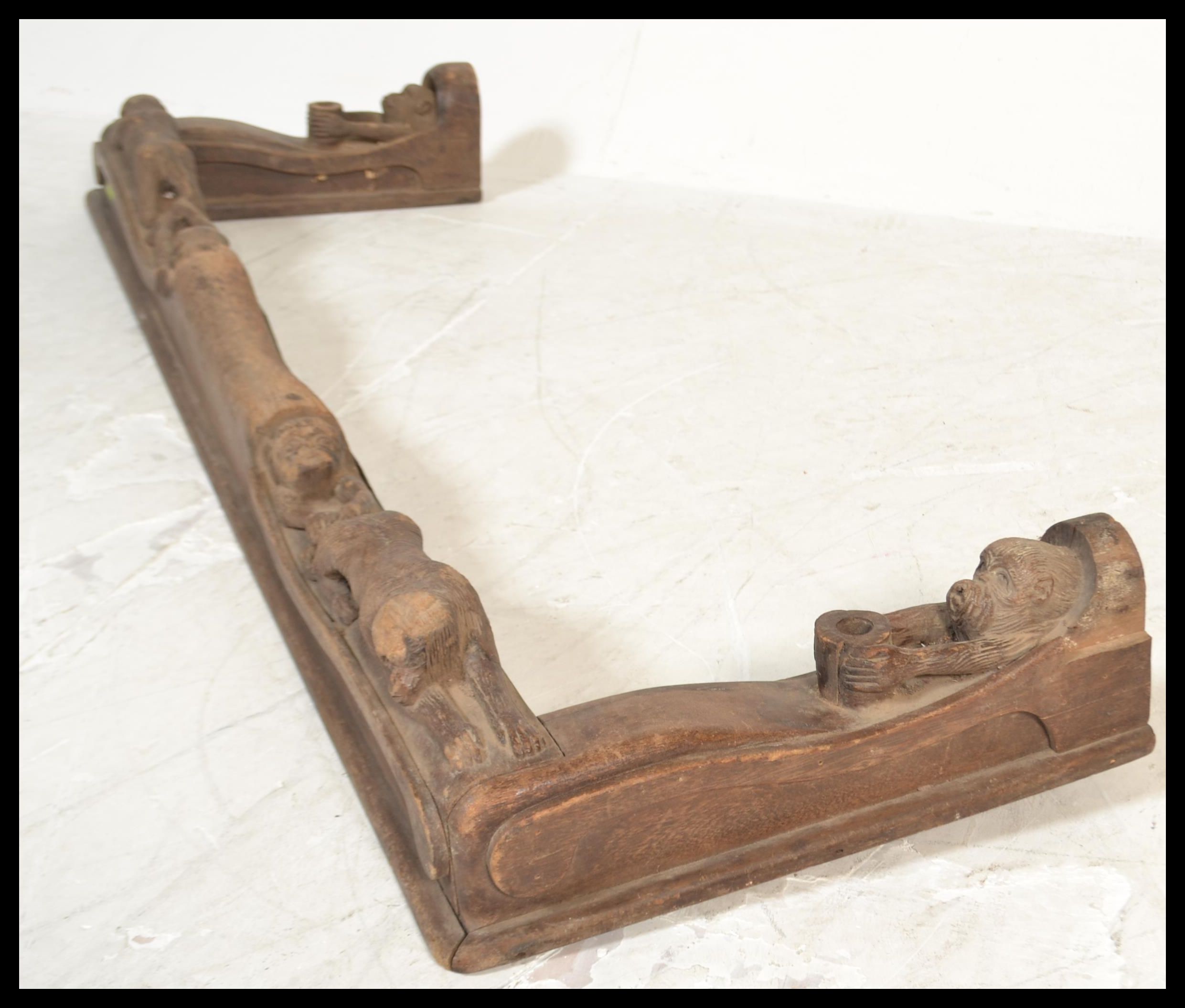 A vintage 20th Century carved oak fire fender kerb of African tribal inspiration, the fender heavily - Image 6 of 7