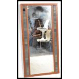 A retro 20th Century teak frames overmantel wall mirror of rectangular form, the central mirror