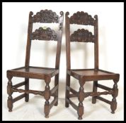A pair of 17th century revival 19th Century carved oak hall chairs, each having a scroll carved