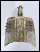 An early 20th century Chinese large brass bell having nail decoration with character marks and