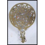 A 19th Century Masonic interest cast brass trivet, the scroll work base incorporating masonic