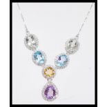 A stamped 925 silver pendant necklace having a collar of amethyst, citrine, and blue topaz having