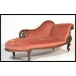 A Victorian 19th century mahogany chaise longue having a scrolled show wood frame with white ceramic