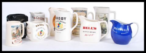 A collection of vintage retro 20th Century whiskey and pub advertising breweriana water jugs