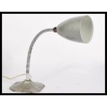An vintage 20th century Industrial retro anglepoise lamp having a goose neck raised on a square base