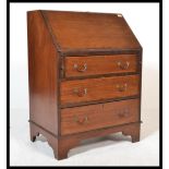 An Edwardian mahogany bureau being raised on brack