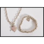 A stamped 925 silver necklace having a toggled clasp with a heart pendant, and a stamped 925