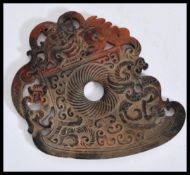 A Chinese 20th Century large carved jade roundel being brown in colour with carved and pierced