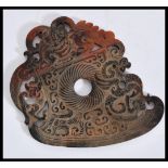 A Chinese 20th Century large carved jade roundel being brown in colour with carved and pierced