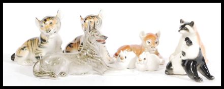 A selection of Lomonosov USSR animal china figurines to include a panda, two tiger cub figurines,