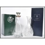 A boxed Thomas Webb clear glass decanter of tapering form having a silver hallmarked collar and