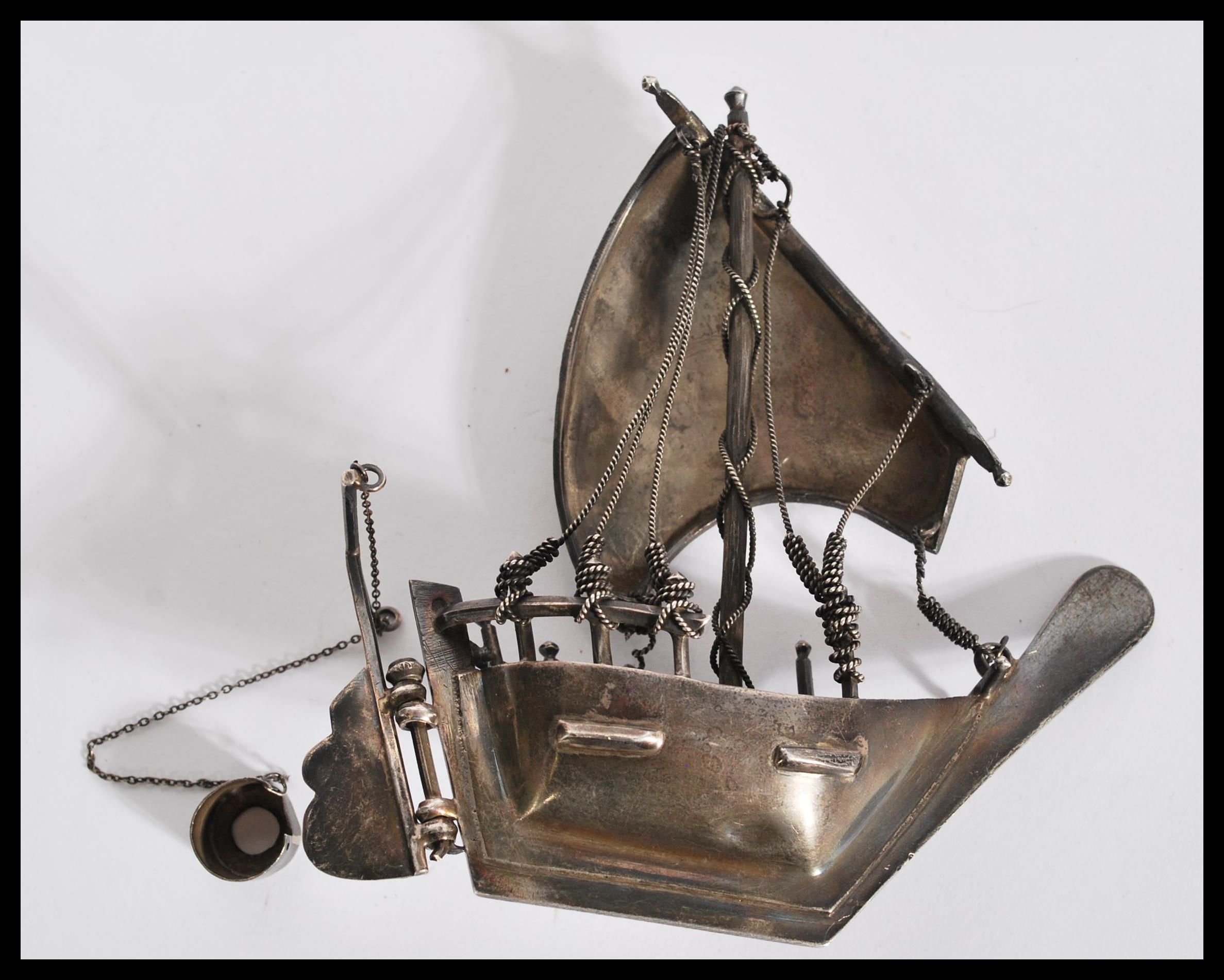 A silver / white metal model of a sailing box complete with sails moving bucket, rudder and ropes. - Image 2 of 4