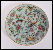 A 19th century Chinese Canton enamel charger plate having hand painted decoration of birds,