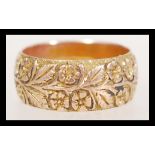 A 19th Century Victorian hallmarked 9ct gold band ring with engraved with floral detailing.