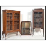 An Edwardian upright pedestal china display cabinet together with a 1930's walnut Queen Anne revival