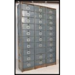 A large Industrial mid century 30 section fall front filing cabinet of metal construction having
