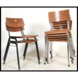 A collection of mid century retro tubular metal and wooden stacking chairs to include grey metal