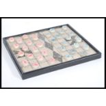 A 20th century Chinese checkers board game having stone counters gaming pieces having calligraphy