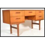 A retro 20th Century teak wood chest of drawers / desk, having a single drawer over knee hole recess