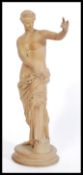 A 19th Century clay / terracotta Grand Tour figurine of a semi nude classical maiden raised on