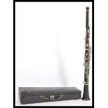 A 20th Century ebonised clarinet having white metal fittings within its original velvet lined and