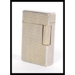 A vintage 20th Century Dupont of Paris white metal pocket lighter having a grid square design.