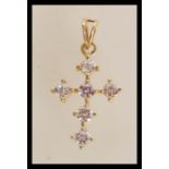 A stamped 375 9ct gold crucifix pendant set with six brilliant cut white stones. Weight 2.7g.