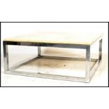 A contemporary large marble and chrome coffee - occasional table. The strapwork chrome base