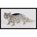 A sterling silver novelty pincushion in the form of a fox with blue baize cushion and ruby eyes.