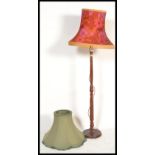 A vintage retro standard lamp having a wooden reeded stand with a 1960's retro shade white a red and