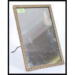 A 19th century bronze wall mirror / easel mirror. The shaped bronze frame with central mirror glass,