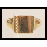 A hallmarked 9ct gold signet ring having a square head with a pattern engraved to one side.