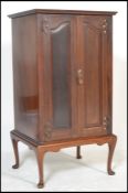 An Edwardian walnut Art Nouveau sheet music pedestal filing cabinet. Raised on cabriole legs with