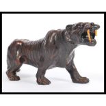 A composite figurine / ornament of a stalking sabre toothed tiger having engraved detailing with