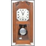 A vintage 20th century Art Deco French walnut cased wall clock, with silvered dial by Vedette having