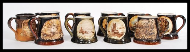 A selection of nine mid century Great Yarmouth pottery ceramic steins / tankards most having brown