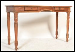 A 20th Century antique Victorian style hardwood side table / writing desk, flared top over two
