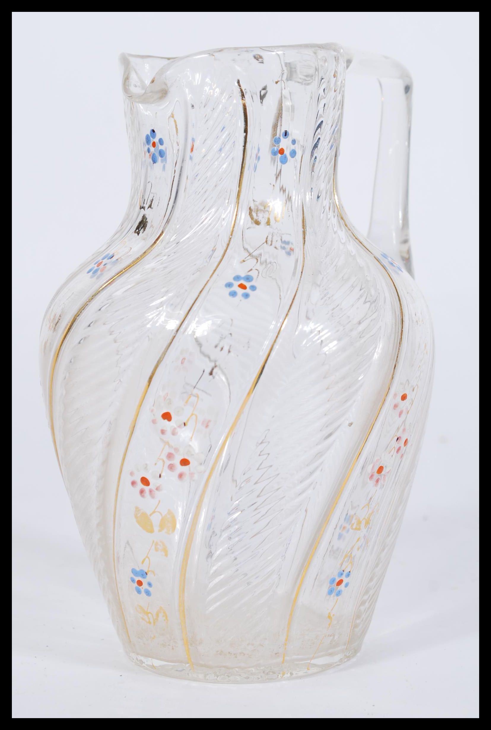 A 19th century Victorian Bohemian style glass jug having hand painted floral decoration with gilt