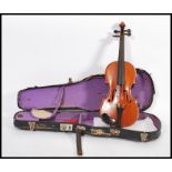 An early 20th century French Le Parisien quarter violin having ebony tuning pegs. In fitted case.