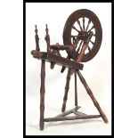 A 19th century North Country mahogany spinning wheel having treadle base with spindle set wheel