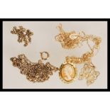 A selection of 9ct gold necklaces to include a stamped 9ct filigree butterfly pendant necklace, a