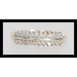 A 9k 9ct gold ring set with two rows of diamonds. Diamond of approx 25pts. Weighs 1.8 grams size O.