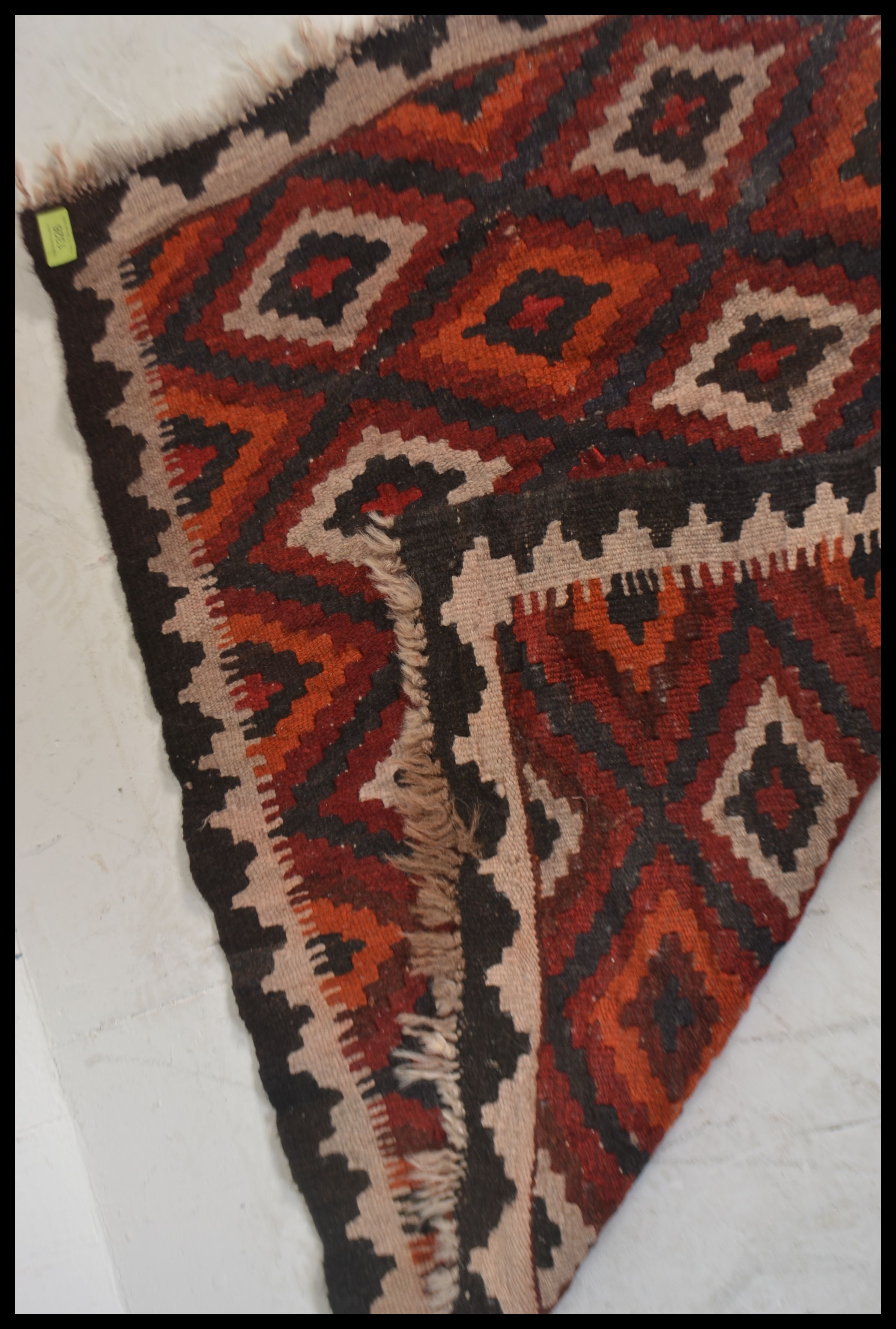 A 20th century  Islamic / Persian rug of small form with geometric patterns and triangular - Image 4 of 4