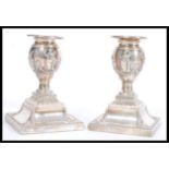 A pair of 19th century Victorian silver hallmarked candlesticks raised on gadrooned square bases