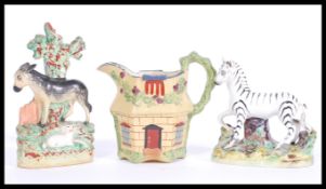 A group of 19th Century English Staffordshire to include a zebra on naturalistic base, donkey