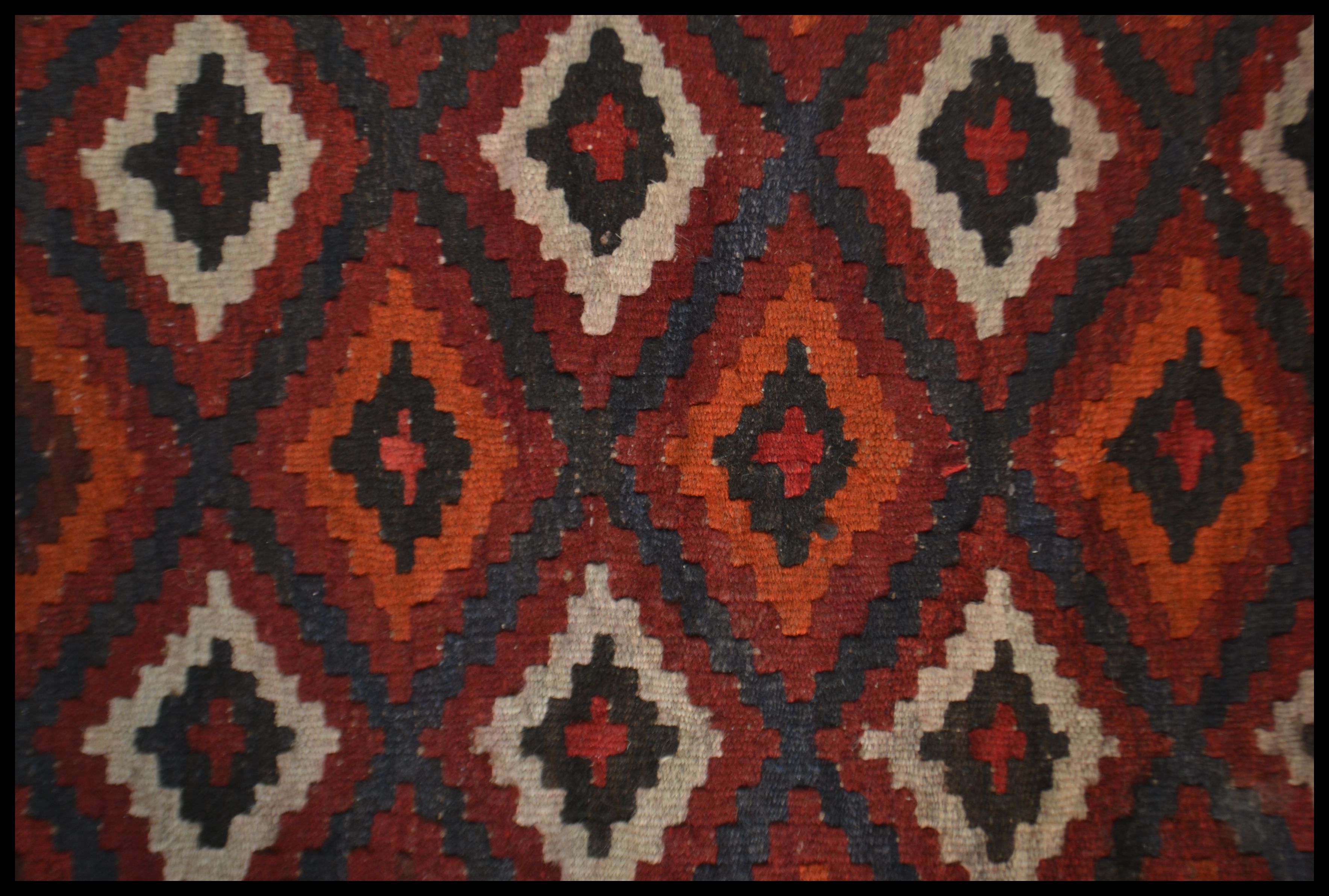 A 20th century  Islamic / Persian rug of small form with geometric patterns and triangular - Image 2 of 4